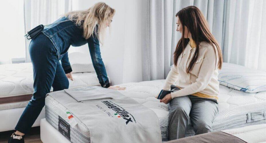 kobiety sprawdzające w salonie twardość materaca